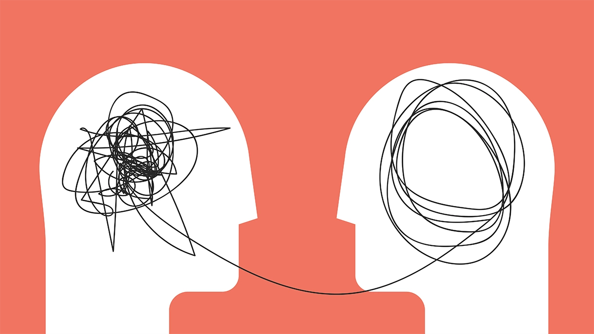 Two white silhouettes of heads face each other on a coral background. One head has a tangled scribble, the other a neater spiral, connected by a line, symbolizing therapy or anxiety treatment through clear communication and understanding.